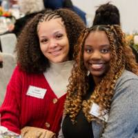 Guests smile at a table during dinner